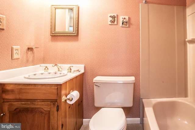 bathroom featuring vanity, toilet, and a bathtub