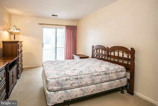 bedroom featuring light carpet