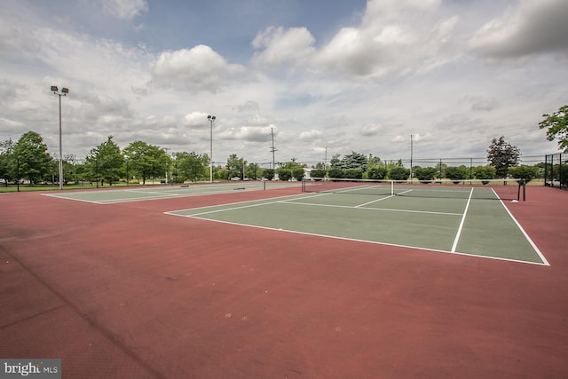 view of tennis court with basketball hoop