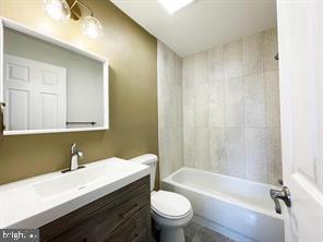 full bathroom with vanity, shower / bathtub combination, and toilet