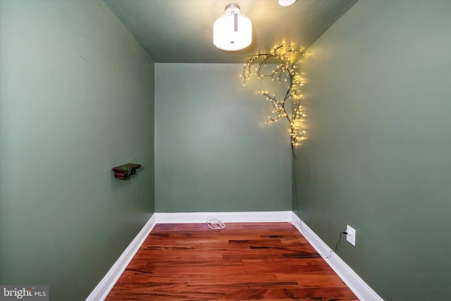 interior space featuring baseboards and wood finished floors