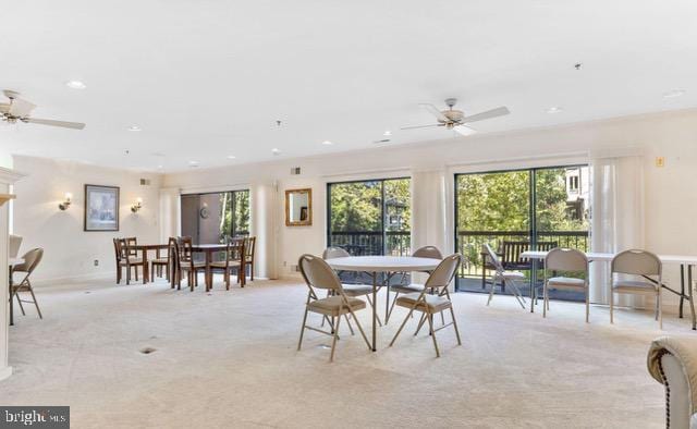 dining room with light carpet, ceiling fan, and recessed lighting