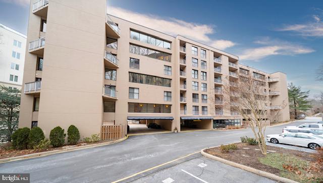 view of property featuring uncovered parking