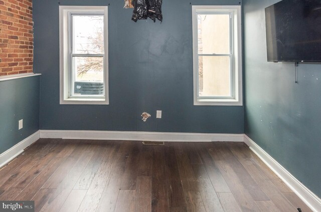 unfurnished room featuring hardwood / wood-style flooring