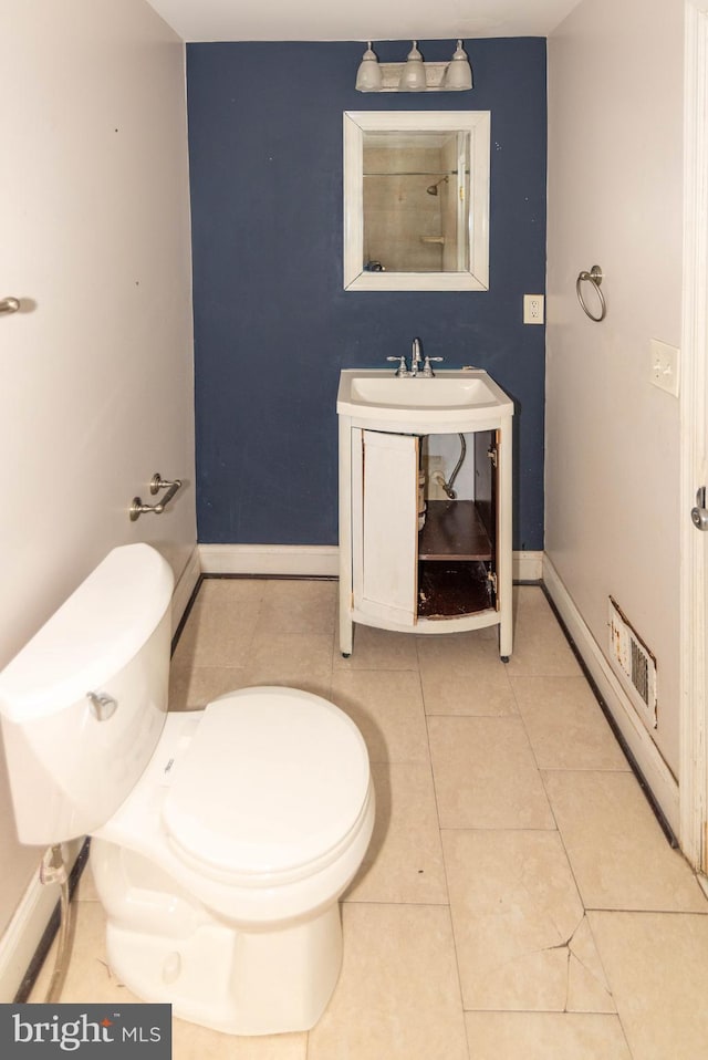 bathroom featuring vanity, toilet, and tile patterned flooring