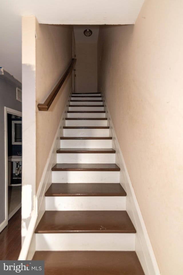 staircase with hardwood / wood-style flooring