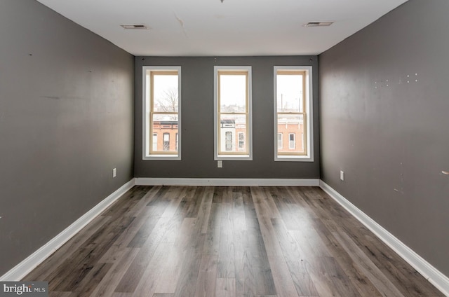 spare room with dark hardwood / wood-style flooring