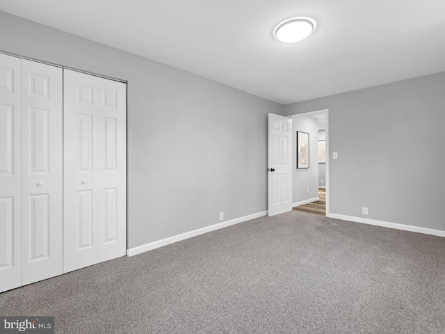 unfurnished bedroom featuring carpet flooring and a closet