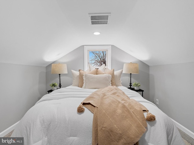 bedroom featuring lofted ceiling and carpet flooring