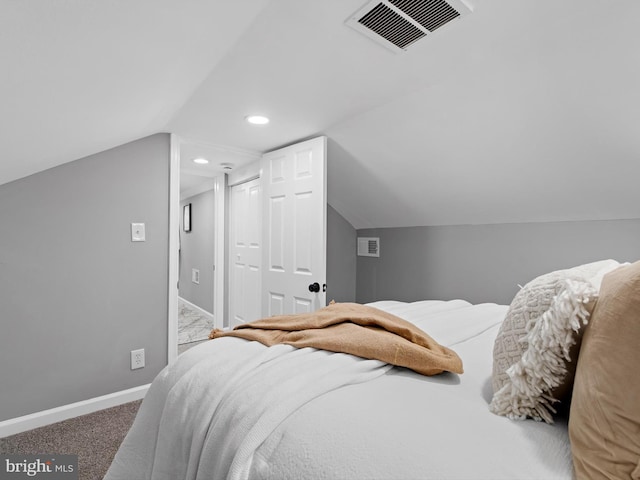 bedroom featuring vaulted ceiling, a closet, and carpet flooring