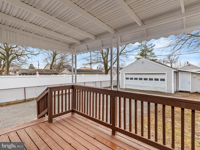 deck featuring an outbuilding and a garage