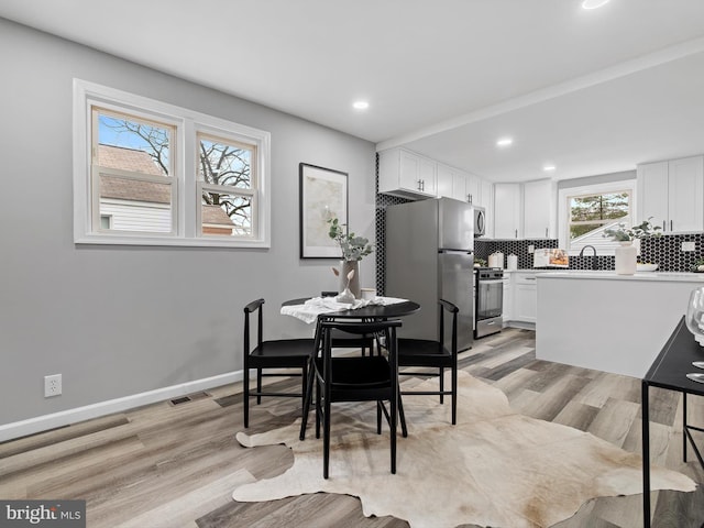 dining area with light wood-type flooring