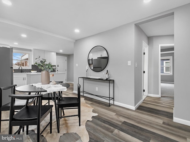 dining space featuring sink and hardwood / wood-style floors