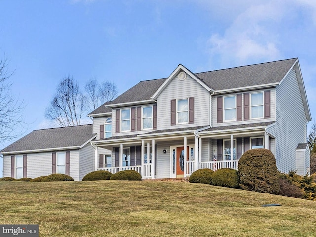 colonial-style house with a porch and a front yard