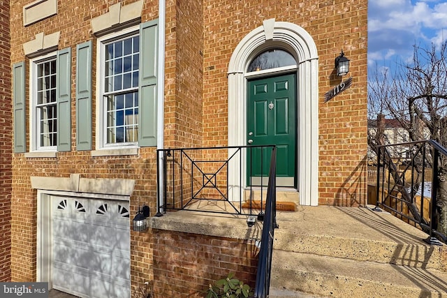 doorway to property with a garage