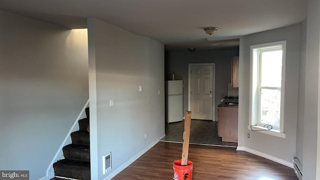 hall featuring dark hardwood / wood-style flooring and baseboard heating