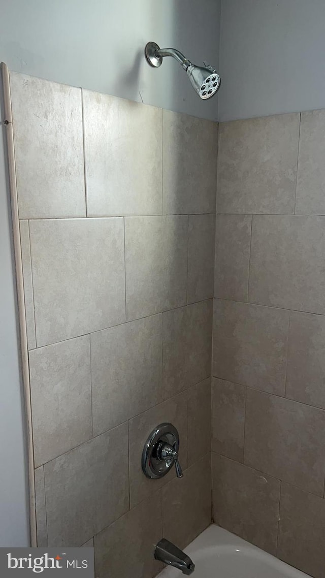 details with tiled shower / bath combo