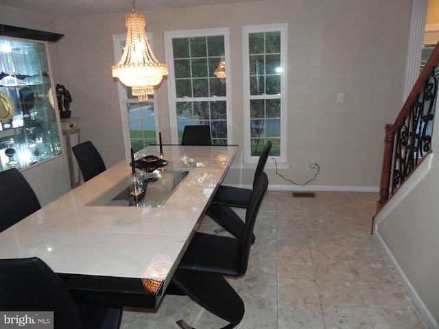 tiled dining space with an inviting chandelier