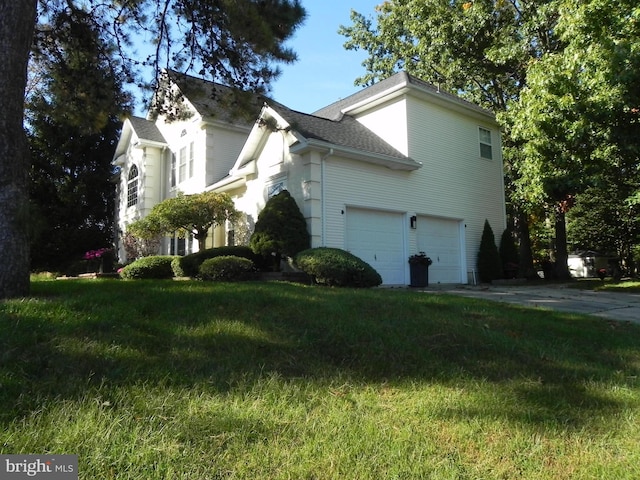 view of property exterior with a garage and a lawn