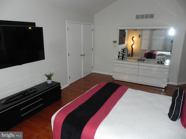 bedroom featuring dark hardwood / wood-style floors and vaulted ceiling