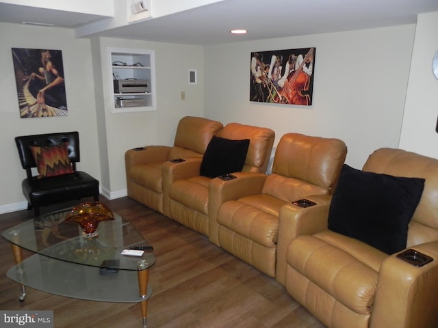 living room with wood-type flooring and built in features