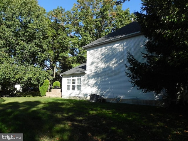 view of property exterior featuring cooling unit and a yard