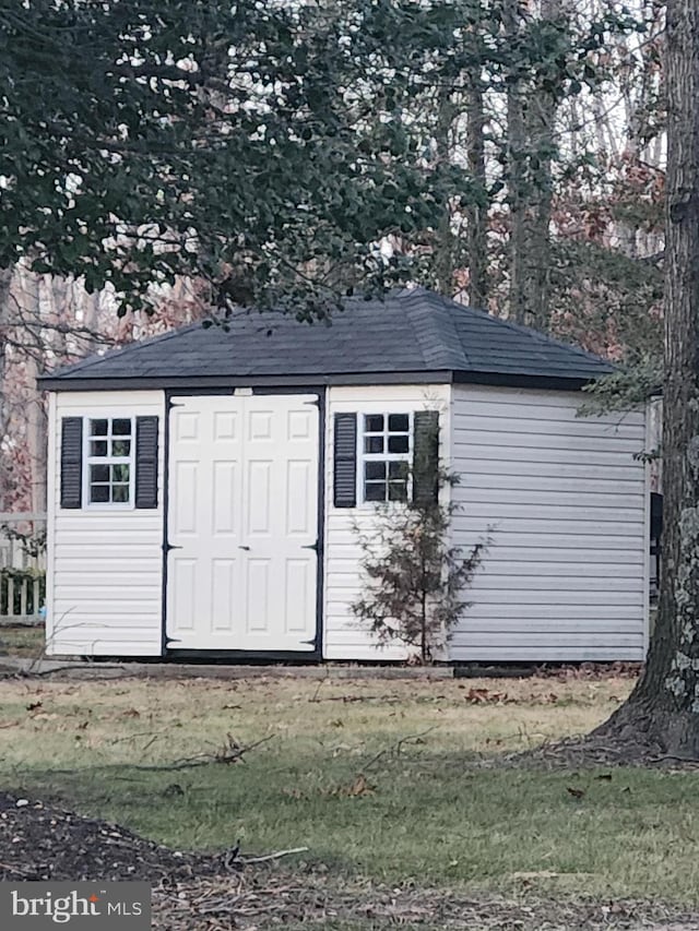 view of outbuilding featuring a lawn