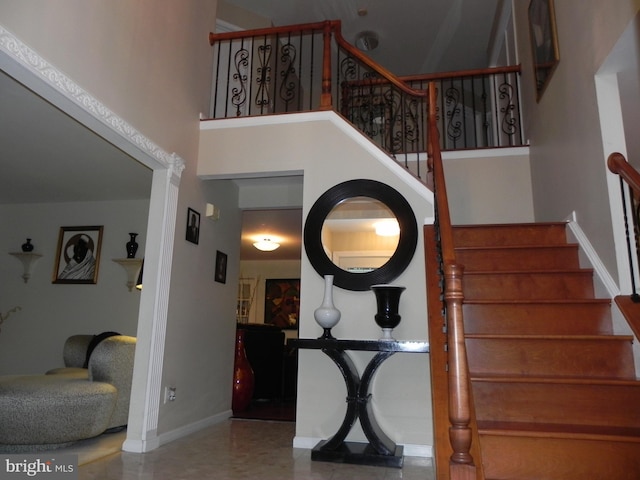 stairs featuring a high ceiling