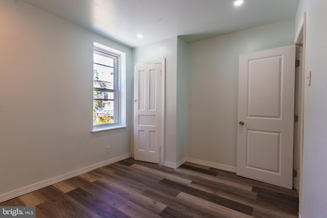 spare room with dark hardwood / wood-style flooring