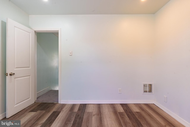 unfurnished room featuring dark hardwood / wood-style flooring