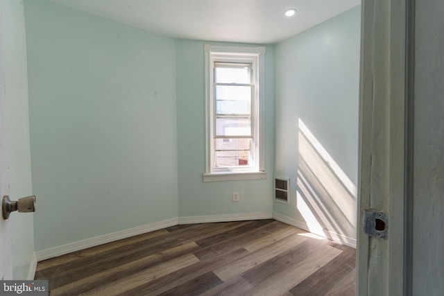 unfurnished room with dark hardwood / wood-style floors