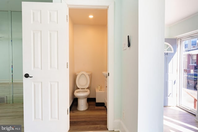 bathroom featuring hardwood / wood-style floors and toilet