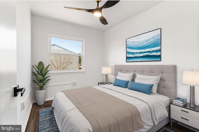 bedroom with dark hardwood / wood-style flooring and ceiling fan