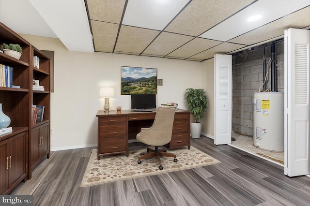 home office with water heater, dark hardwood / wood-style floors, and a paneled ceiling