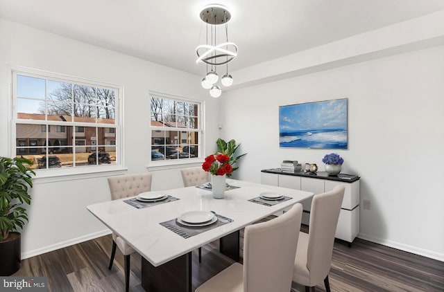 dining space featuring dark hardwood / wood-style floors and an inviting chandelier