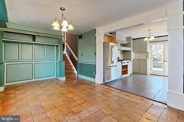 kitchen with an inviting chandelier, decorative light fixtures, stainless steel appliances, and green cabinetry