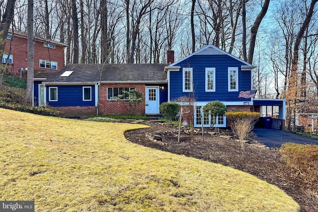 split level home with a carport and a front yard