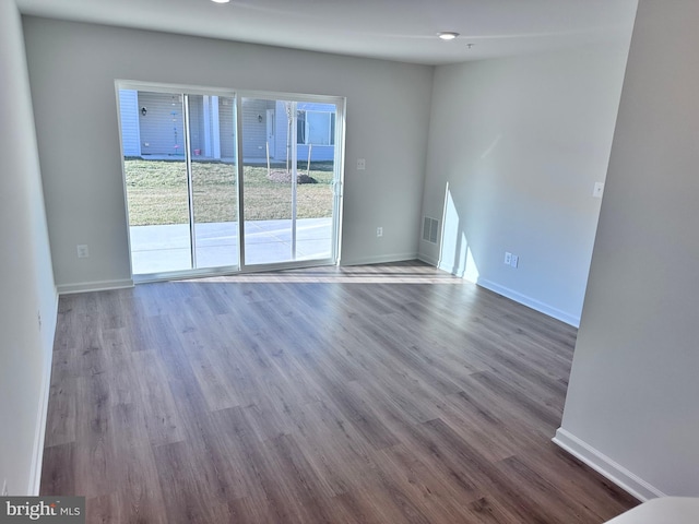 unfurnished room with hardwood / wood-style flooring