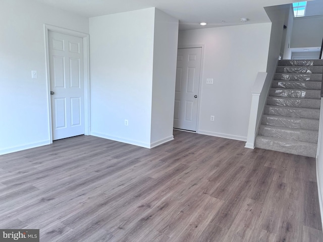 spare room with wood-type flooring