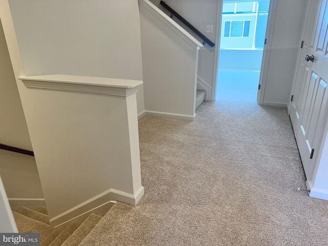 hallway with light colored carpet