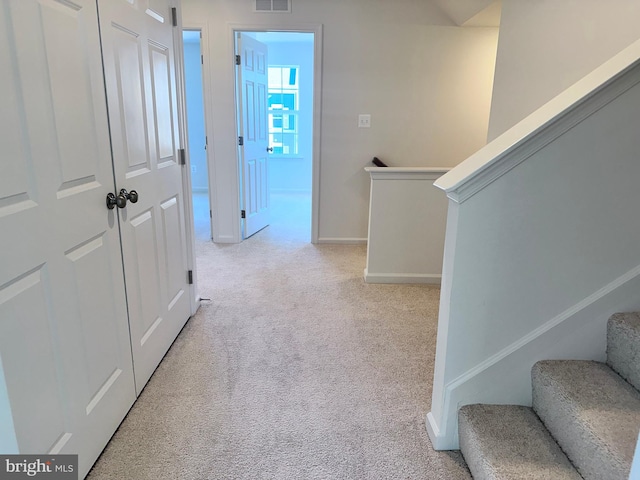 hallway featuring light carpet