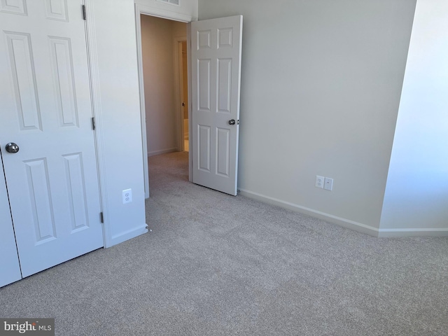 unfurnished bedroom with light colored carpet