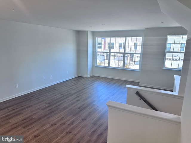 spare room with dark hardwood / wood-style flooring