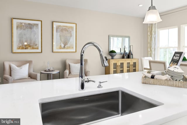 interior details featuring sink and decorative light fixtures