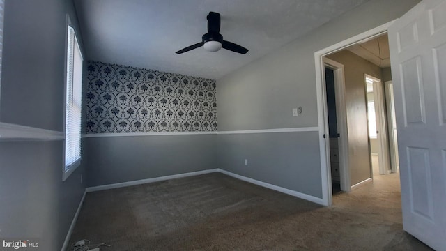 carpeted empty room featuring ceiling fan