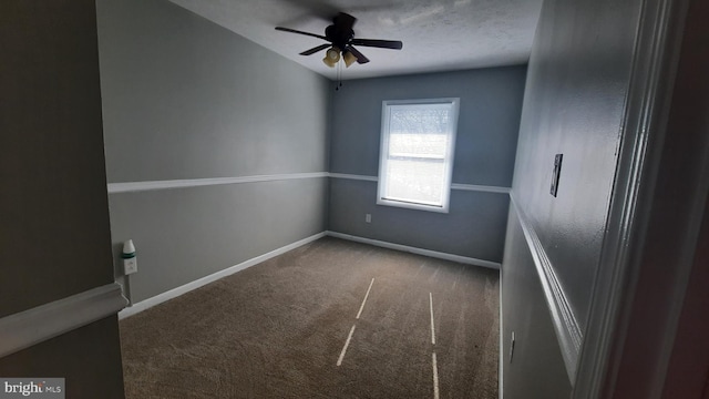 carpeted spare room featuring a textured ceiling and ceiling fan