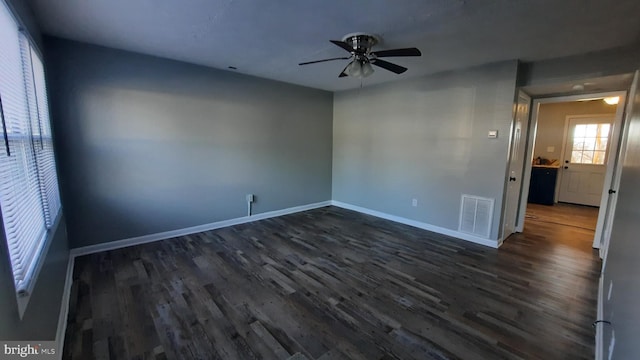 empty room featuring ceiling fan and dark hardwood / wood-style floors