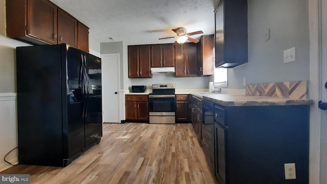 kitchen with sink, black fridge, stainless steel range with electric stovetop, dark brown cabinets, and light hardwood / wood-style flooring