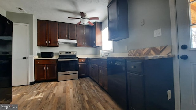 kitchen with sink, ceiling fan, black dishwasher, light hardwood / wood-style floors, and stainless steel electric range oven