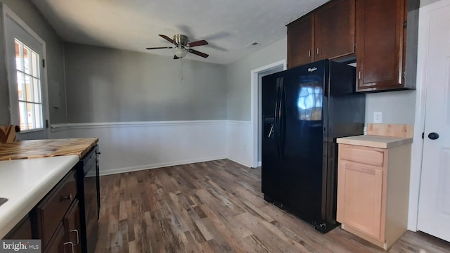 kitchen featuring dark brown cabinets, light hardwood / wood-style flooring, ceiling fan, and black appliances